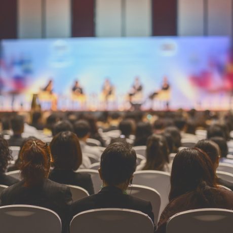 Rear view of Audience listening Speakers on the stage in the conference hall or seminar meeting, business and education about investment concept